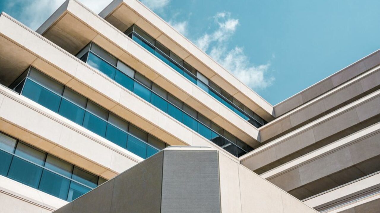 Close view of a contemporary building façade with horizontal banding and glazing.