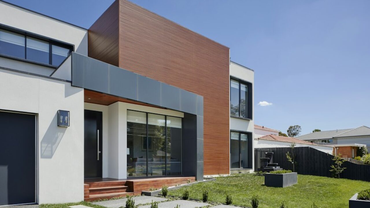 Concept visual: a modern two-storey duplex residence with brick and render façades.