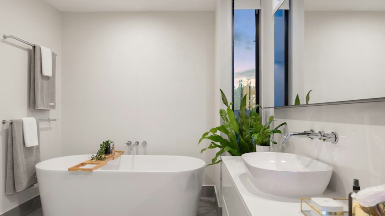 Concept visual: a contemporary bathroom with a freestanding tub and large-format wall tiles.