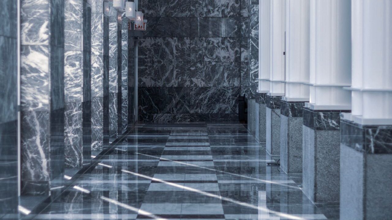 Polished marble floor tiles in a bright interior corridor.