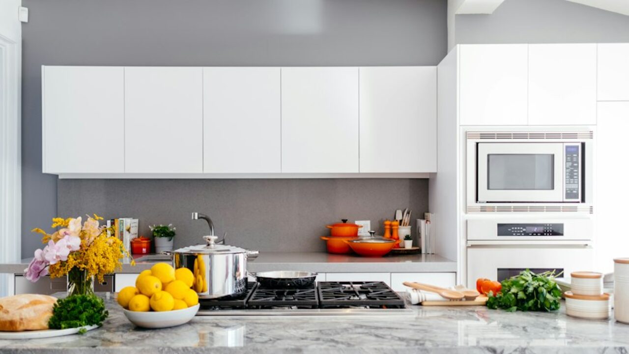 Concept visual: a modular kitchen with handleless cabinetry and stone counters.