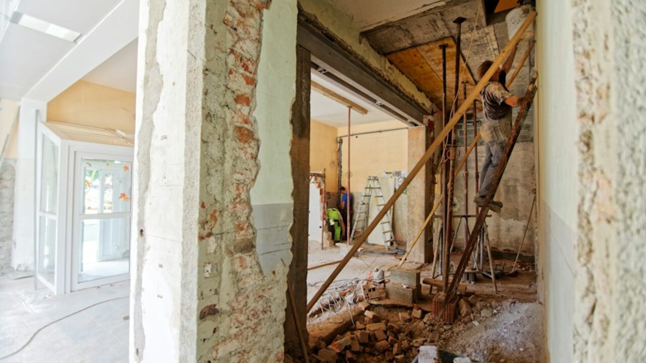 Interior of a house during renovation with stripped plaster and exposed structure.